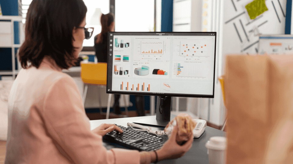 Professional analyzing data on a computer screen, emphasizing Web Design KL.